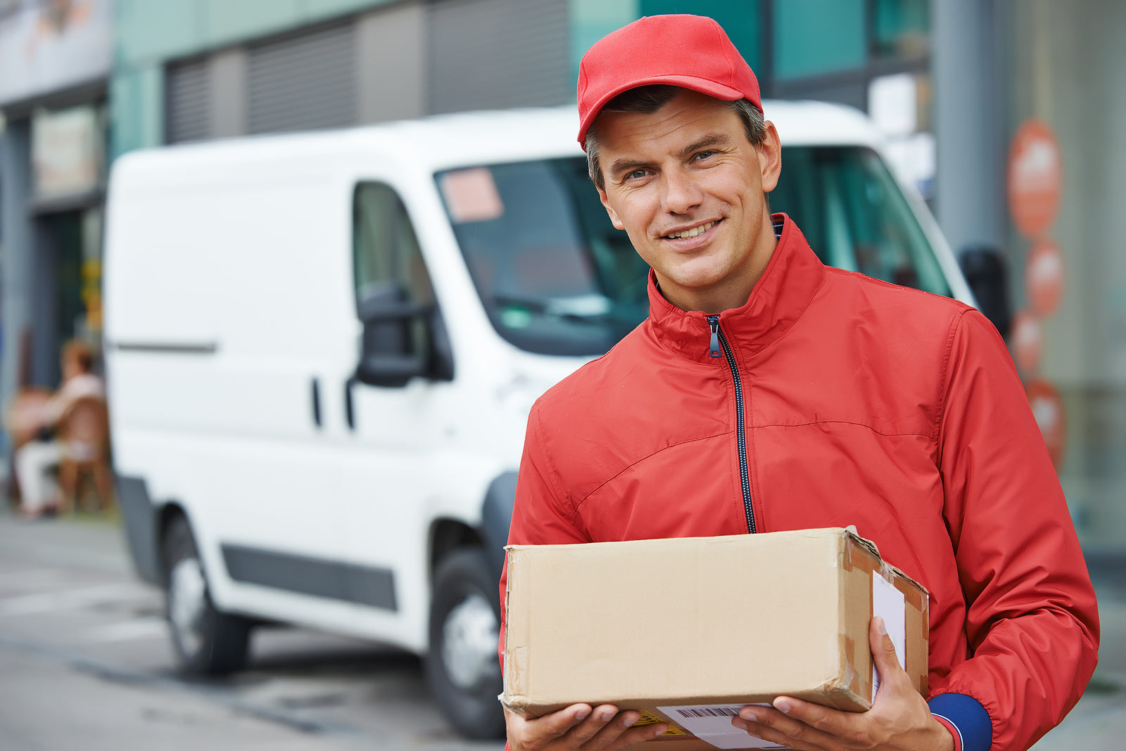 Bespoke packaging solutions - postal delivery courier man in front of cargo van