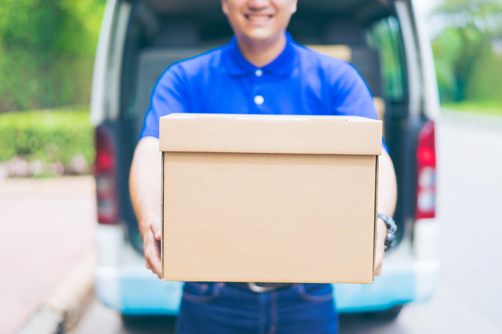 Postal packaging - delivery courier man in front of cargo van