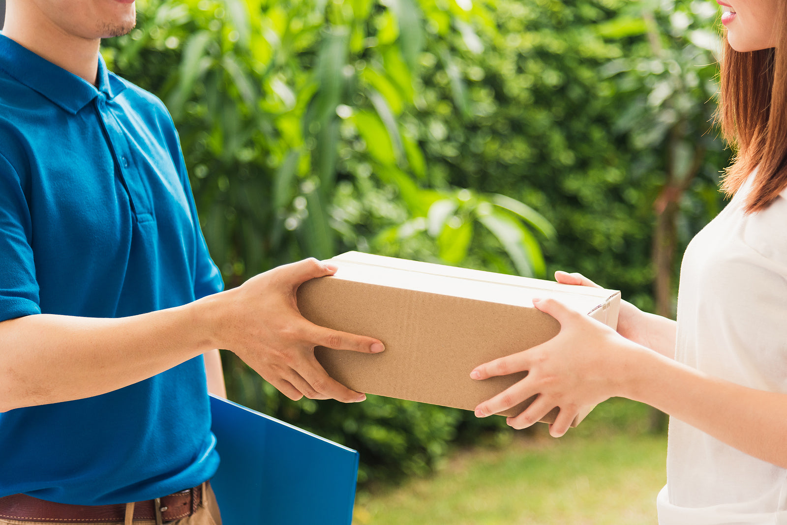Postal packaging - delivery man courier in uniform