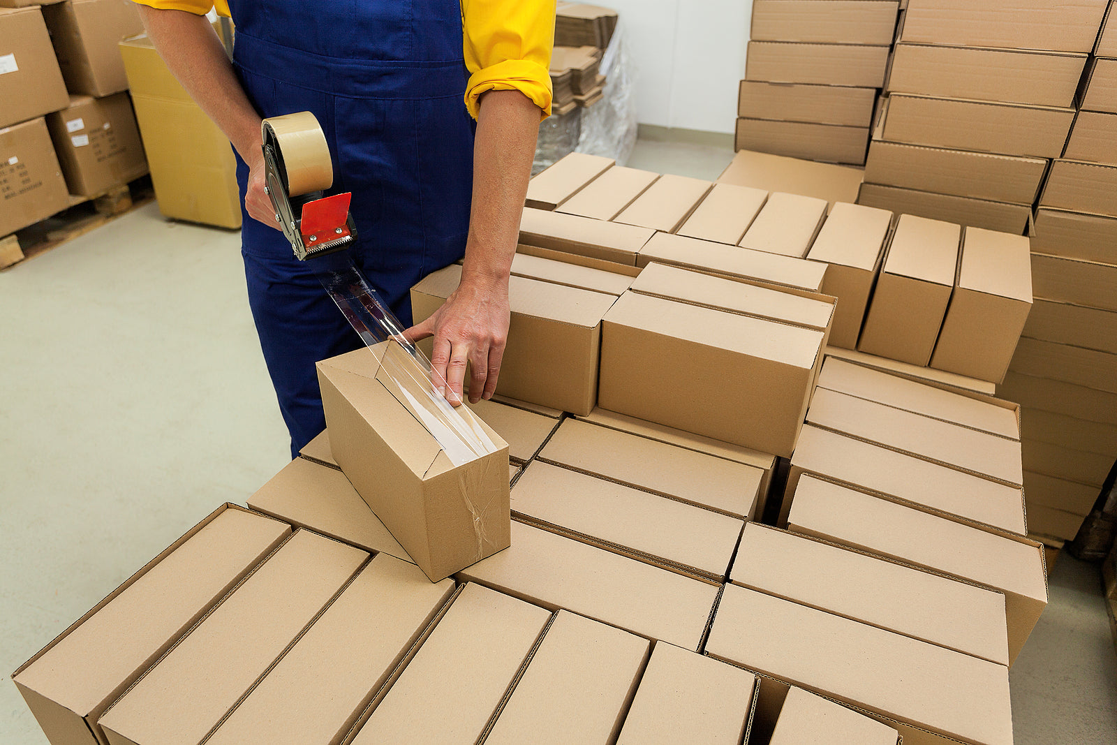 custom cardboard boxes - Warehouse worker packaging produc