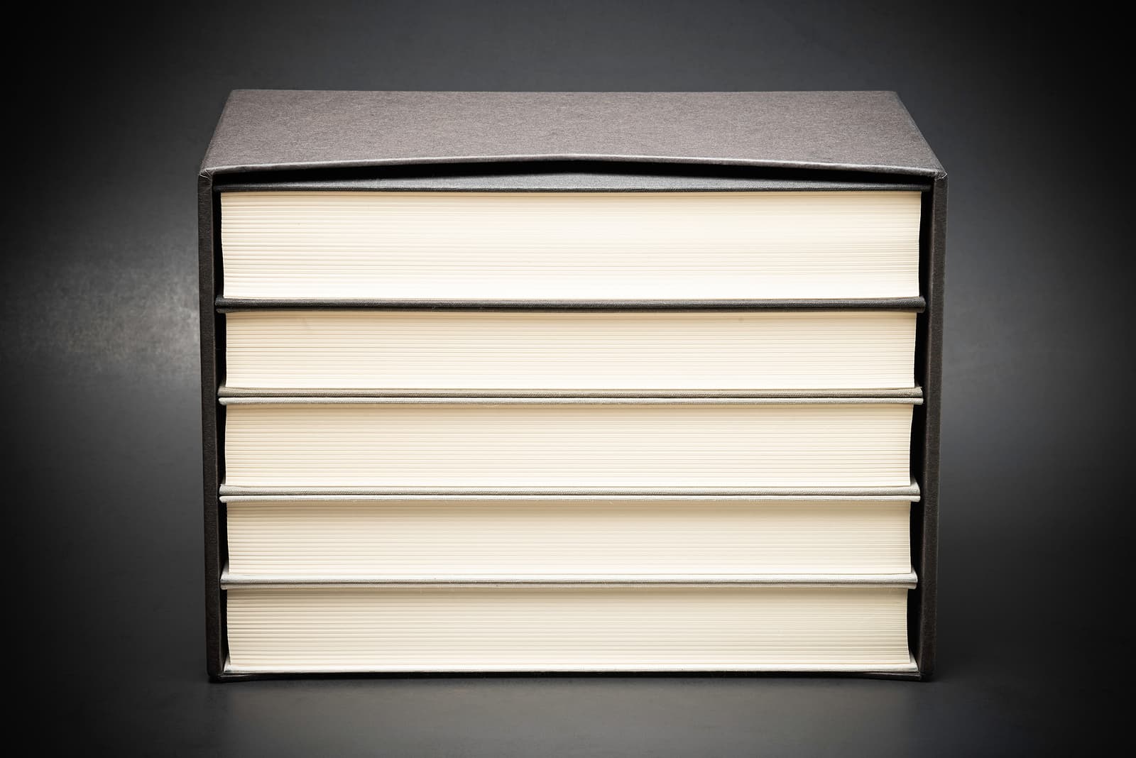 custom cardboard boxes - books stored inside a black hard cardboard slipcase