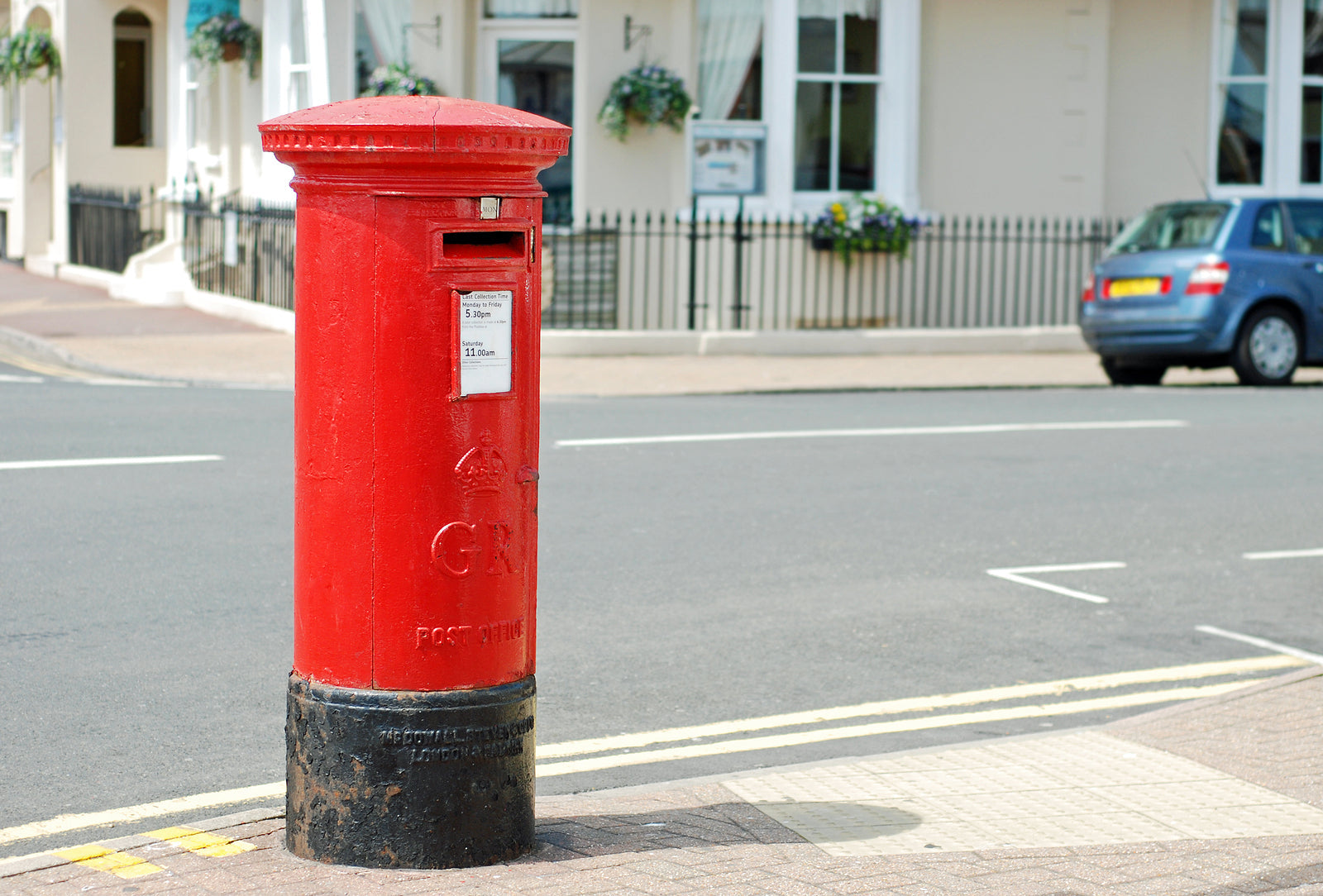 custom cardboard boxes - red British mailbox on the corner of a street