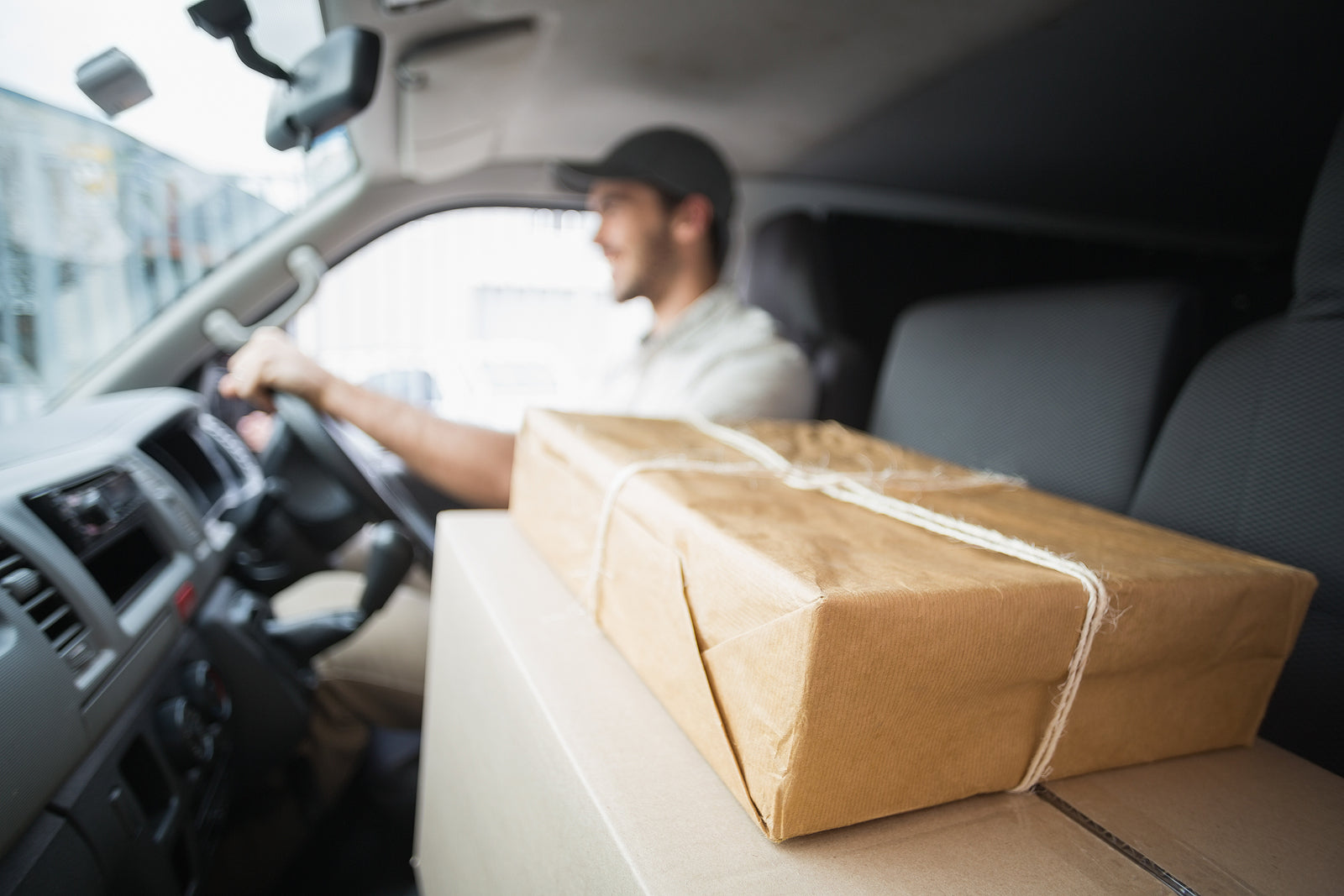 postal boxes - Delivery driver driving van with parcels